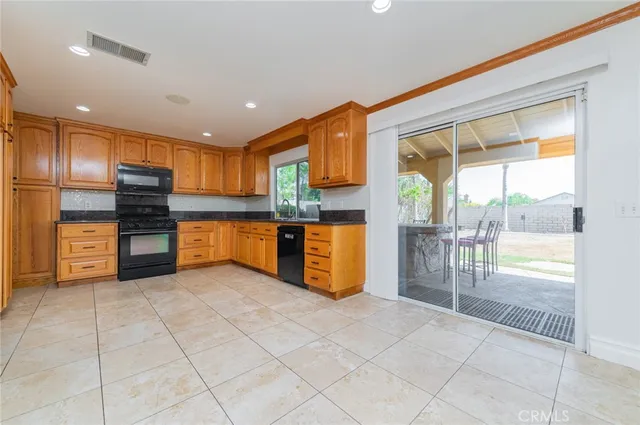 a kitchen with stainless steel appliances a refrigerator and cabinets