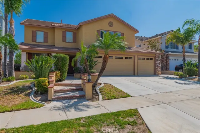 a front view of a house with a yard and potted plants