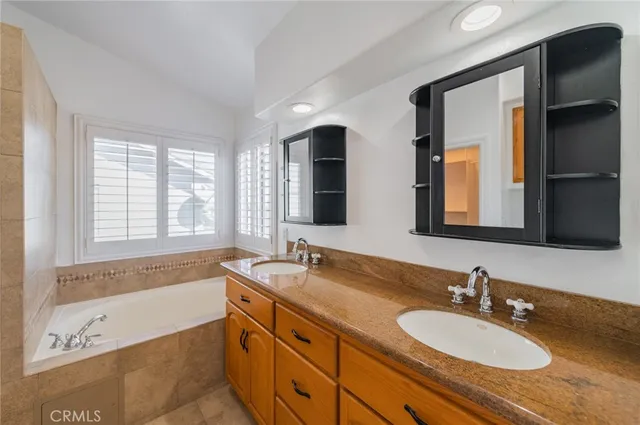a bathroom with a tub shower and sink