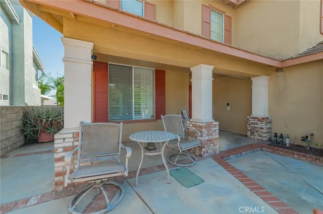 a view of a patio with table and chairs and potted plants