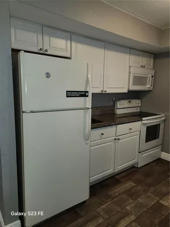 a white refrigerator freezer sitting inside of a kitchen