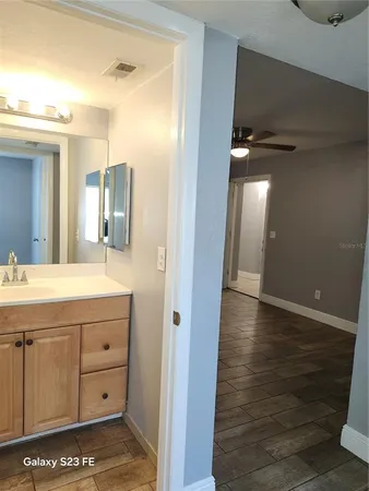a bathroom with a sink a mirror and a shower