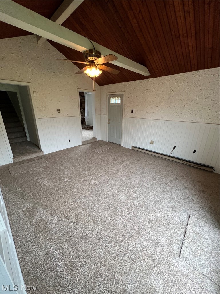 545 7th Street Struthers, OH 44471 - Photo 6 of 17 Empty room featuring ceiling fan, vaulted ceiling with beams, and carpet flooring