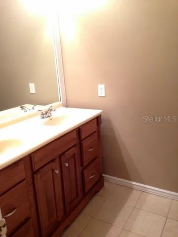a bathroom with a sink vanity and a mirror