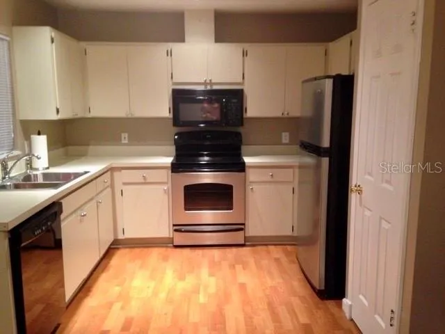 a kitchen with a sink and a refrigerator