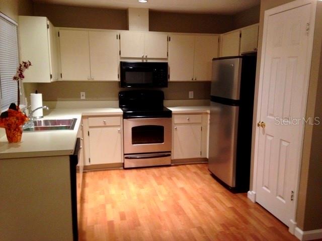 8330 Duval Drive Port Richey, FL 34668 - Photo 4 of 20 a kitchen with a stove and a refrigerator