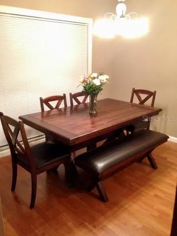 a view of a dining room with furniture and wooden floor