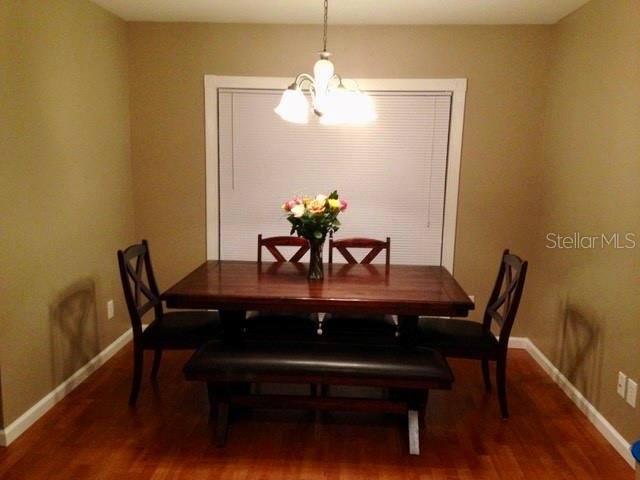 8330 Duval Drive Port Richey, FL 34668 - Photo 6 of 20 a view of a dining room with furniture and wooden floor