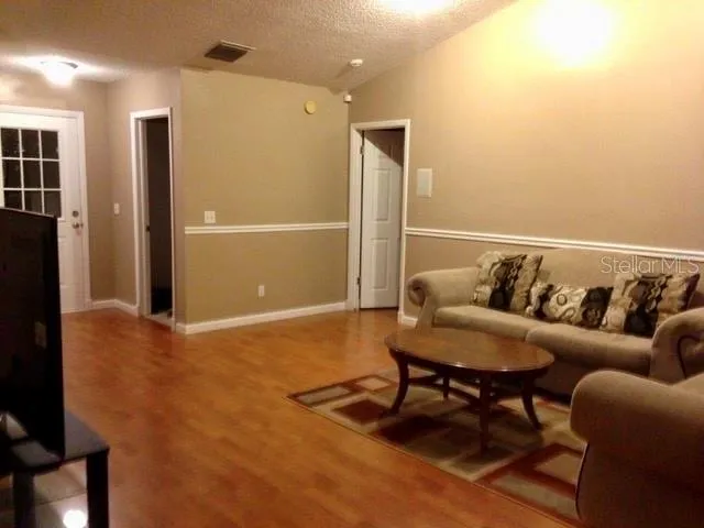 a living room with furniture and a rug