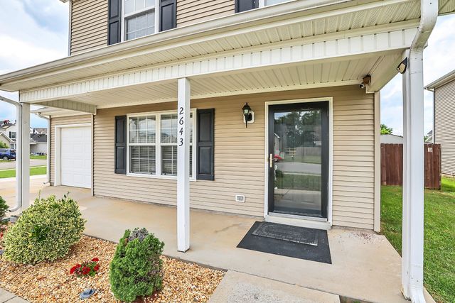 a bedroom with a bed and a dresser next to a window