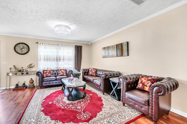 a view of a house with a yard and sitting area