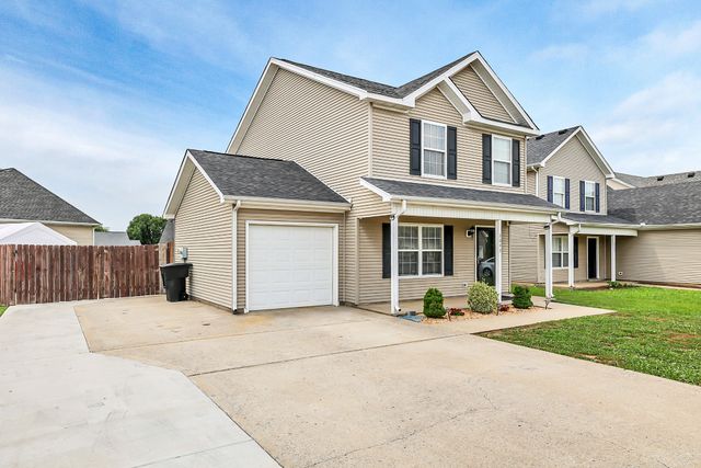 a kitchen with stainless steel appliances granite countertop a stove a microwave and a sink