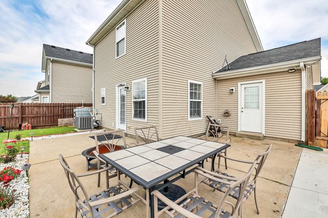 a kitchen with stainless steel appliances granite countertop a sink and a refrigerator