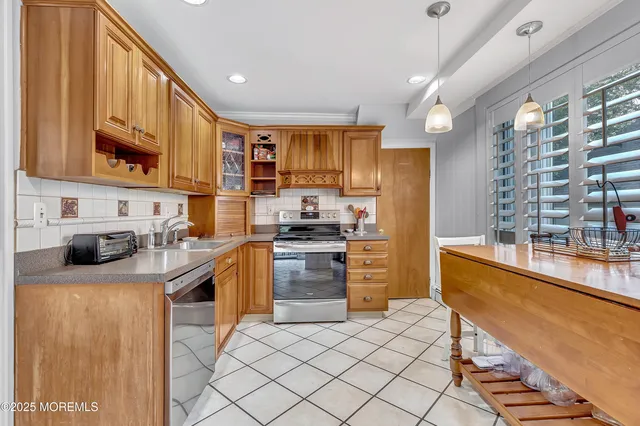a kitchen with stainless steel appliances kitchen island granite countertop a sink and cabinets