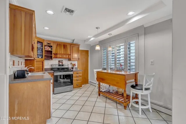 a kitchen with stainless steel appliances kitchen island granite countertop a sink and cabinets