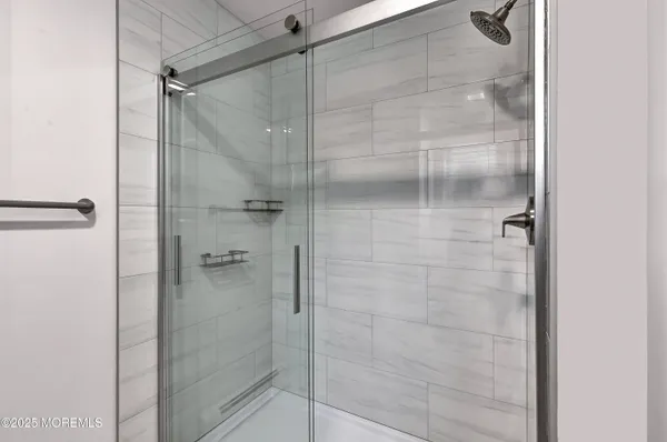 a bathroom with a glass shower door