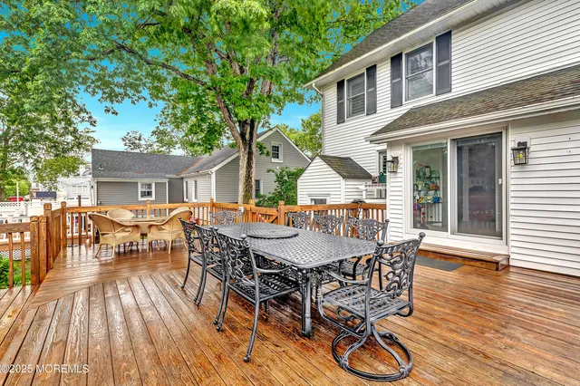 a view of a patio with table and chairs and wooden floor
