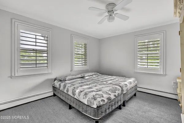 a bedroom with a bed dresser and a window