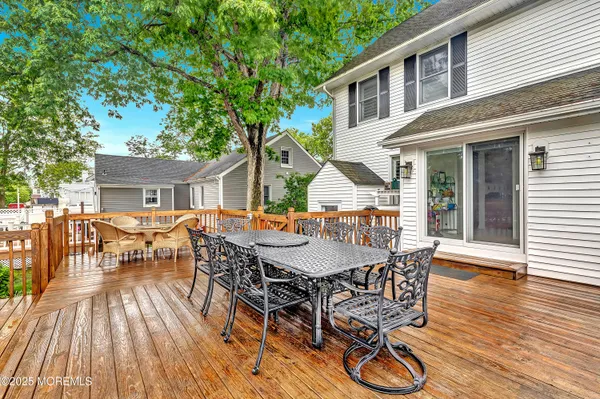 a view of a patio with table and chairs and wooden floor