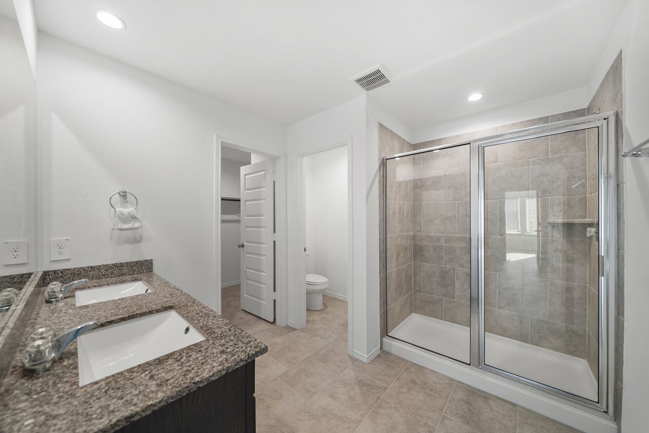 7502 Fierce Friesian Lane Rosharon, TX 77583 - Photo 10 of 21 a bathroom with a granite countertop sink and shower