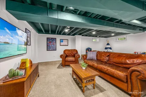 a roof deck with couch and a potted plant