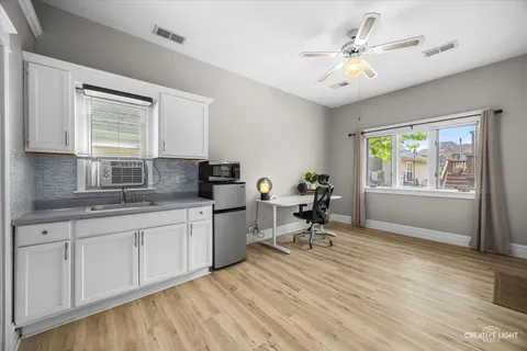 a view of a workspace with furniture and wooden floor