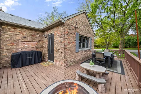 a view of deck with table and chairs and wooden floor