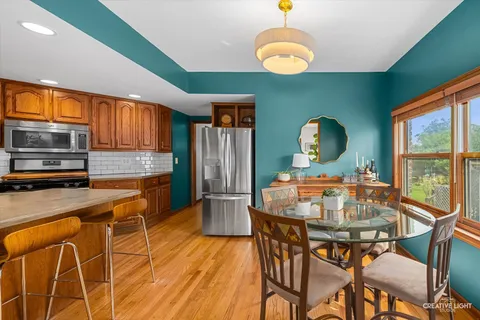 a view of a dining room with furniture window and wooden floor