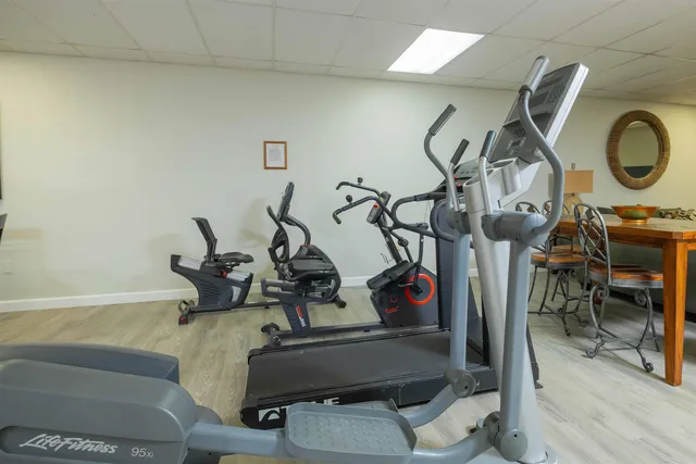 a view of a workspace with furniture window and wooden floor