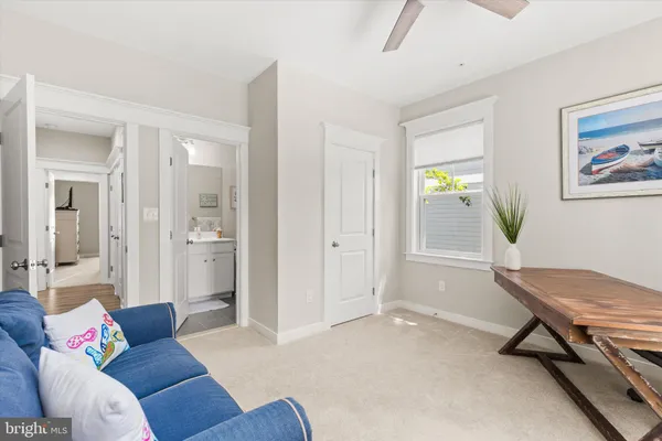 a bedroom with a bed and painting on the wall