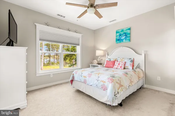 a roof deck with table and chairs potted plants with wooden floor and fence