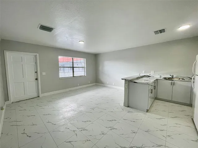 a view of a kitchen with a sink cabinets and a window