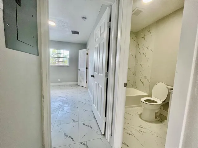 a bathroom with a sink a toilet and a bathtub