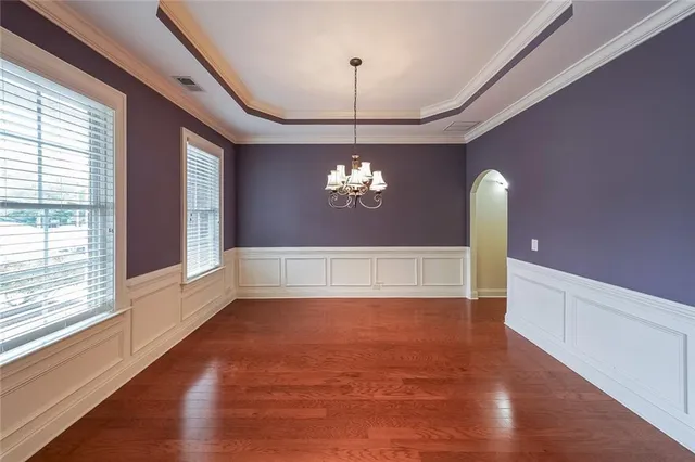 a view of a livingroom with a window and wooden floor