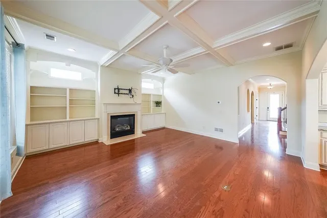 a view of a livingroom with wooden floor and a fireplace