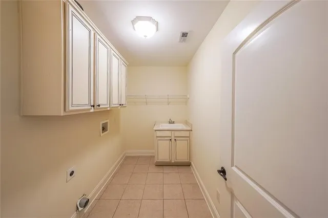 a view of a kitchen with white cabinets