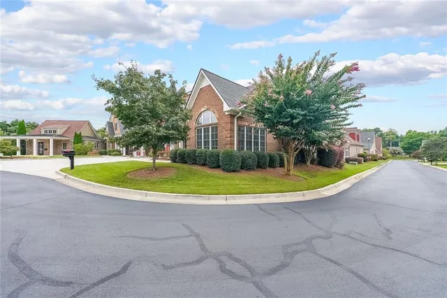 a view of a house with a swimming pool and a yard