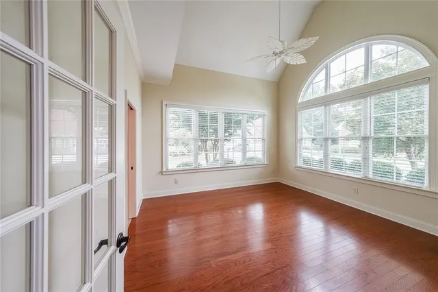 wooden floor in an empty room with a window