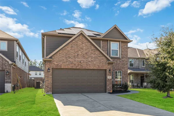 a front view of a house with a yard and garage