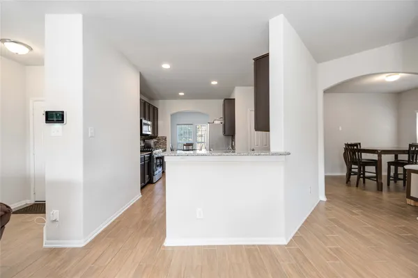 a view of kitchen with furniture and wooden floor