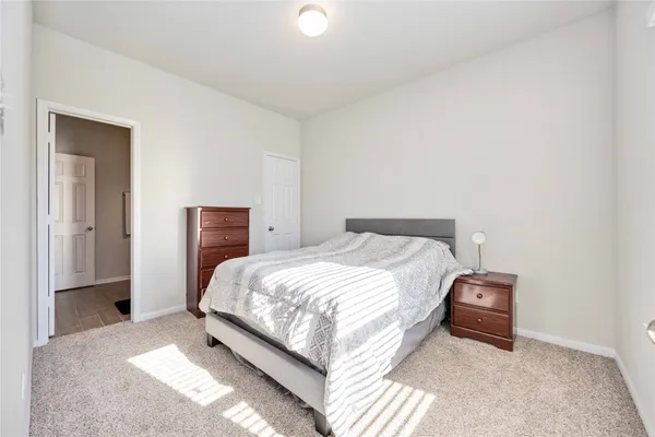 a bedroom with a bed and a lamp