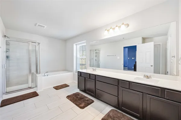 a bathroom with a bathtub and shower