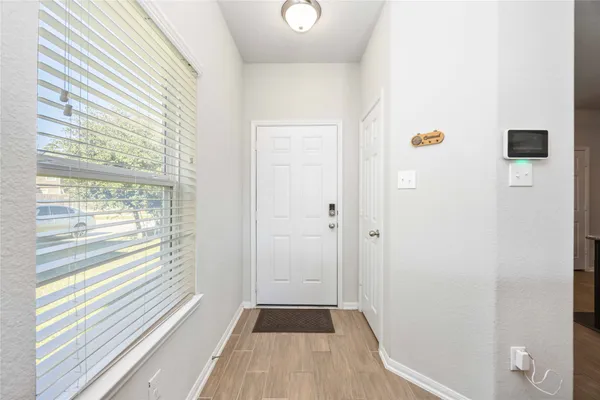 a view of a livingroom with wooden floor and window