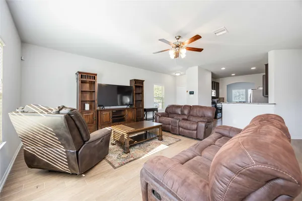 a living room with furniture ceiling fan and a rug