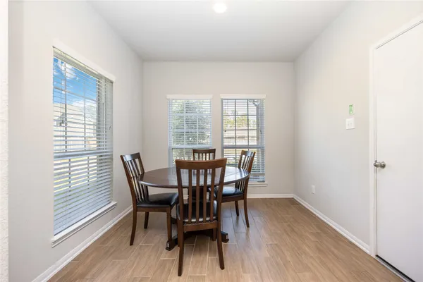 a view of a dining room with furniture and wooden floor