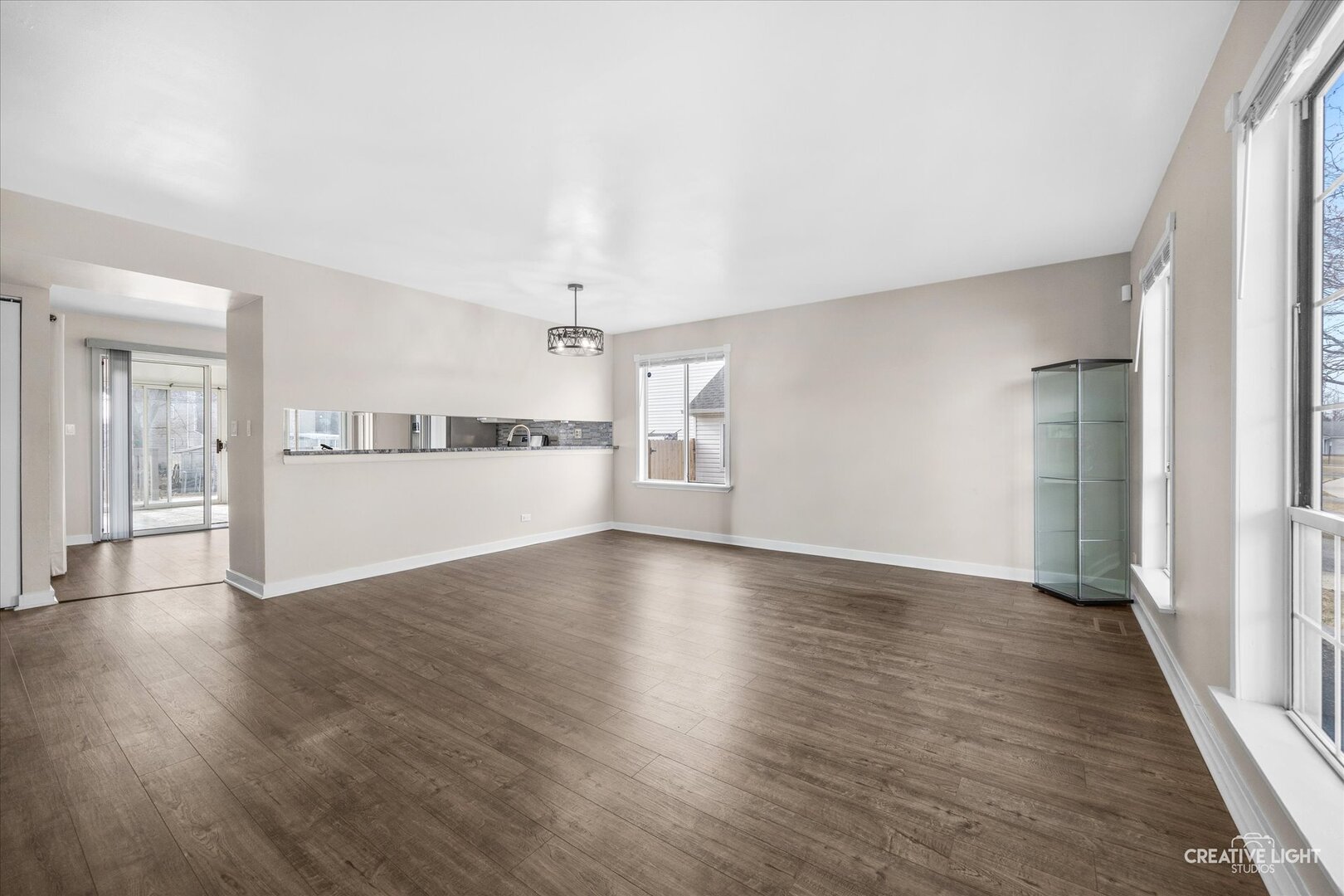 1221 Longford Circle Elgin, IL 60120 - Photo 4 of 29 wooden floor in an empty room with a kitchen