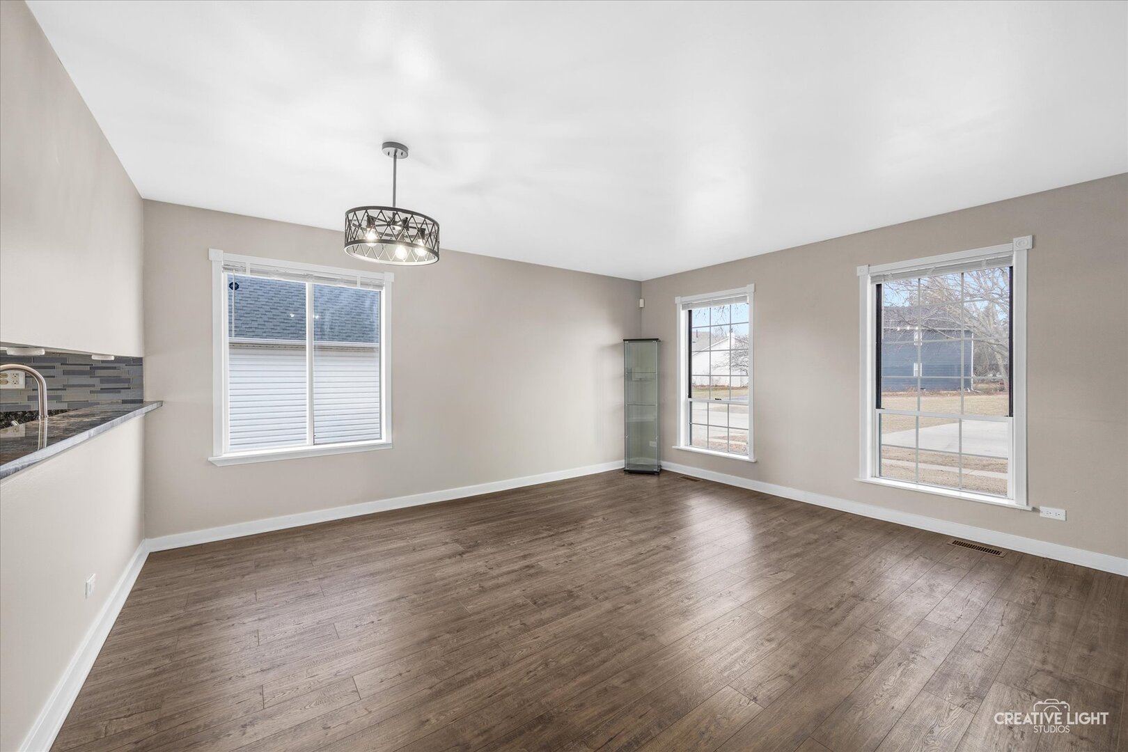 1221 Longford Circle Elgin, IL 60120 - Photo 5 of 29 a view of an empty room with wooden floor and a window