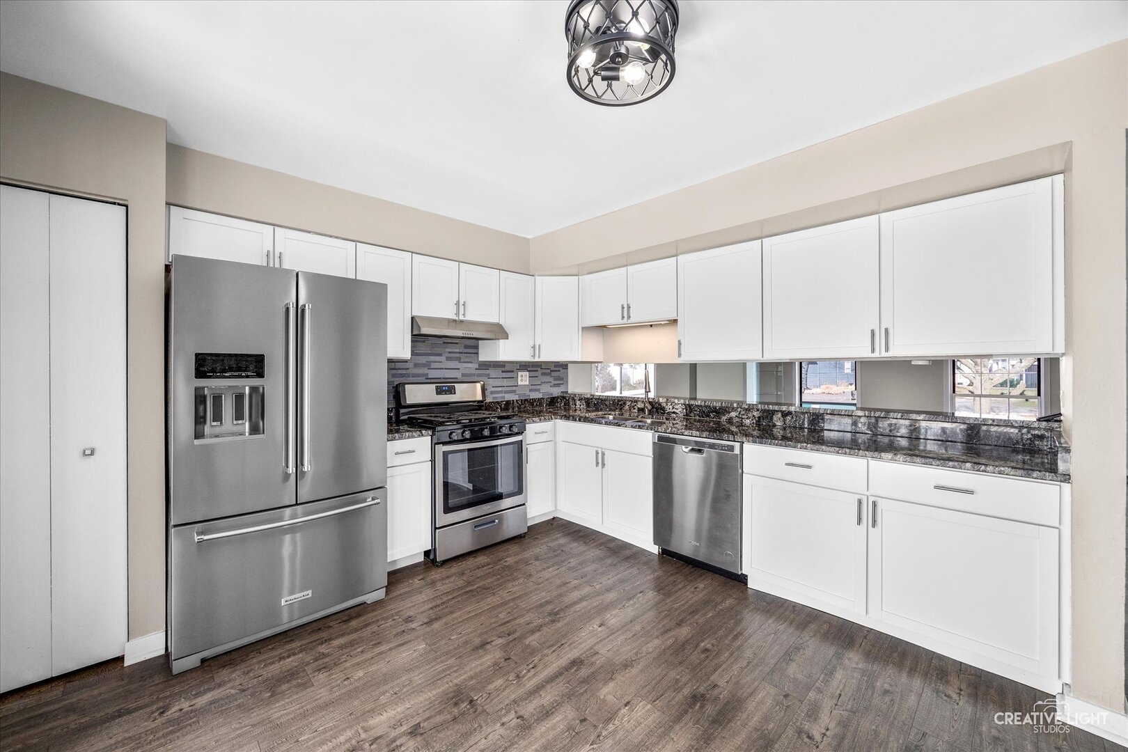 1221 Longford Circle Elgin, IL 60120 - Photo 6 of 29 a kitchen with granite countertop white cabinets and stainless steel appliances