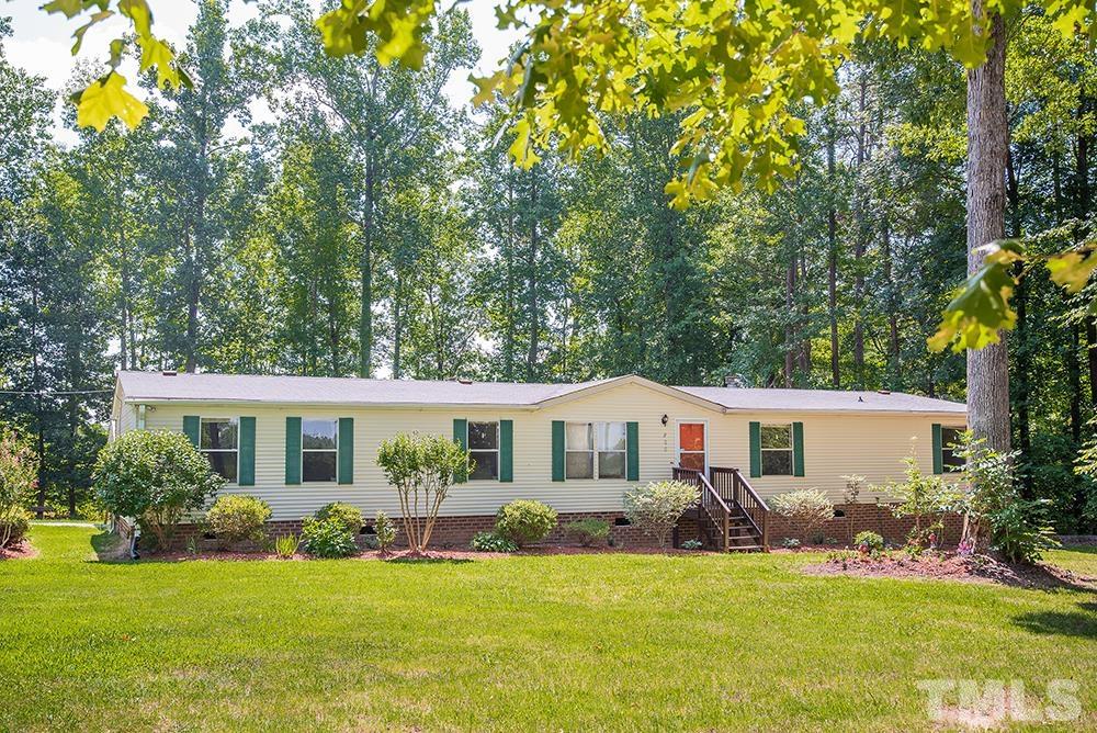 800 Woodsdale Road Roxboro, NC 27574 - Photo 1 of 54 a front view of a house with a yard