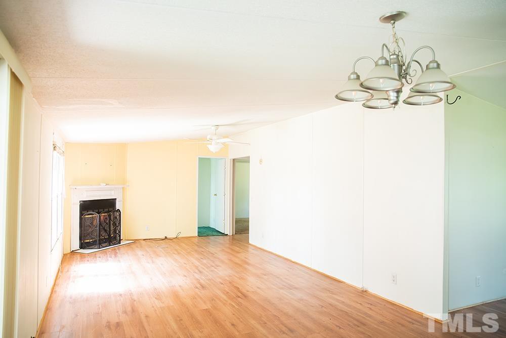 800 Woodsdale Road Roxboro, NC 27574 - Photo 11 of 54 a view of empty room with wooden floor